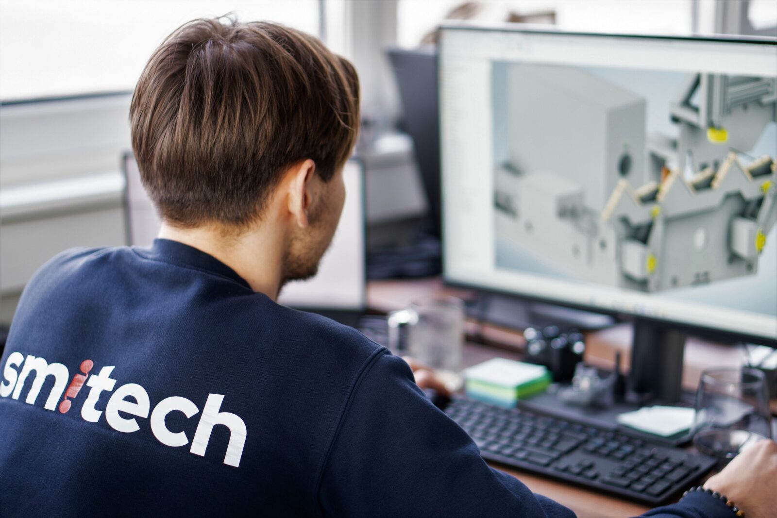 Engineer designing production line and looking at the screen